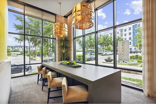 Modern clubhouse with sleek design and communal seating at Domain at Midtown Park Apartments, ideal for gatherings and leisure activities