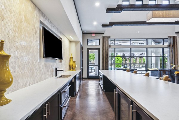 Clubhouse featuring sleek design and ample seating at Domain at Midtown Park Apartments, perfect for social gatherings or relaxation