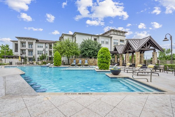 Outdoor poolside lounging area at Domain at Midtown Park, luxury apartments featuring modern amenities