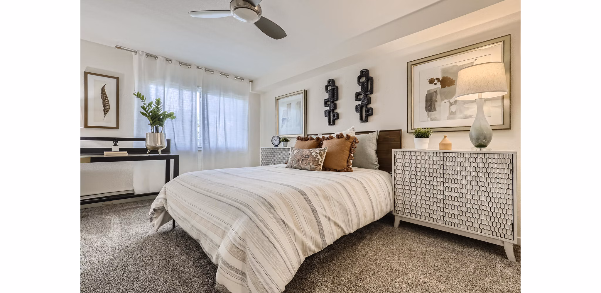 Avantus Apartments: Cozy bedroom with modern furnishings and large windows