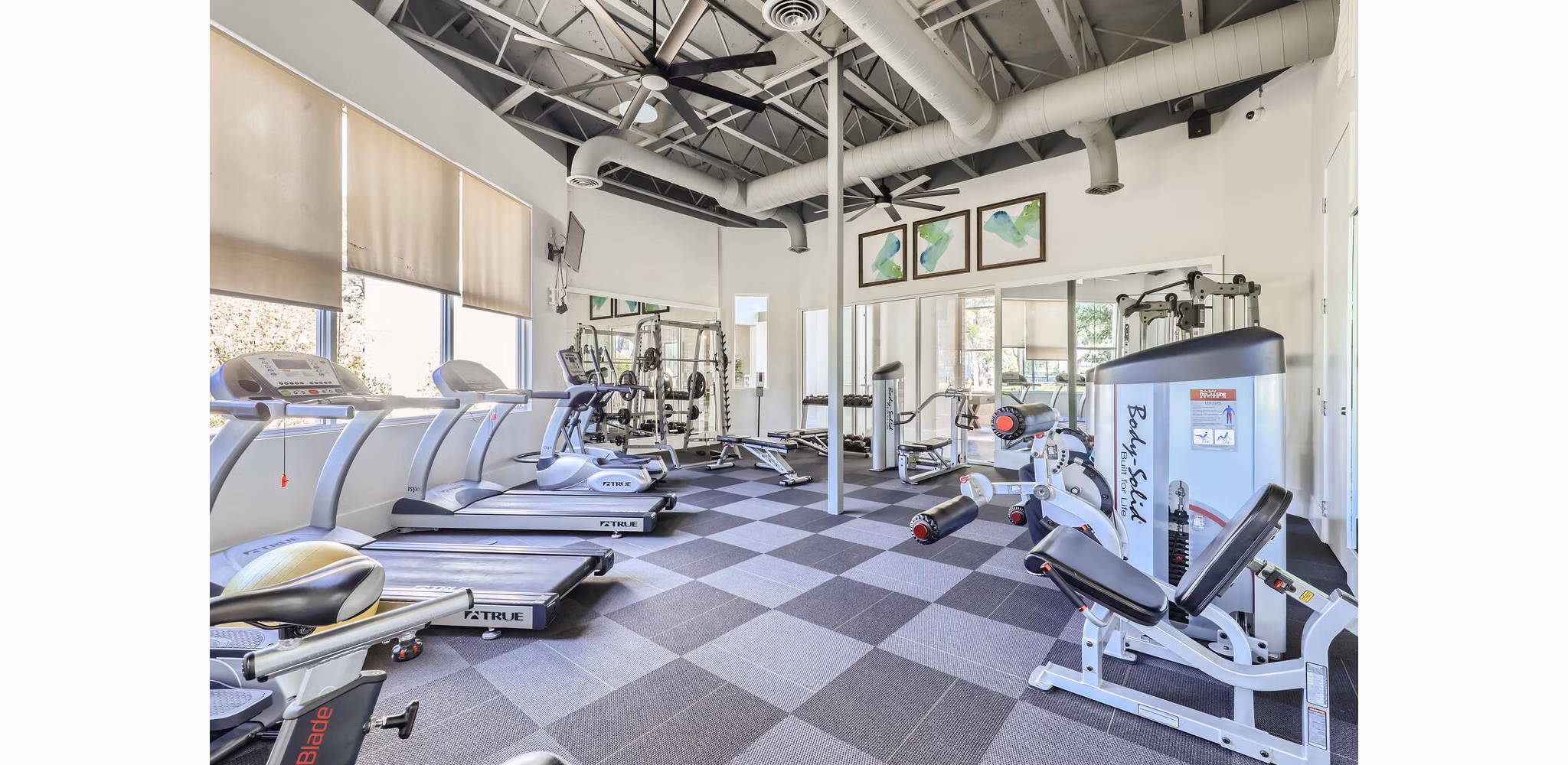 Spacious fitness center with advanced equipment at Avantus Apartments offers luxury workout experience