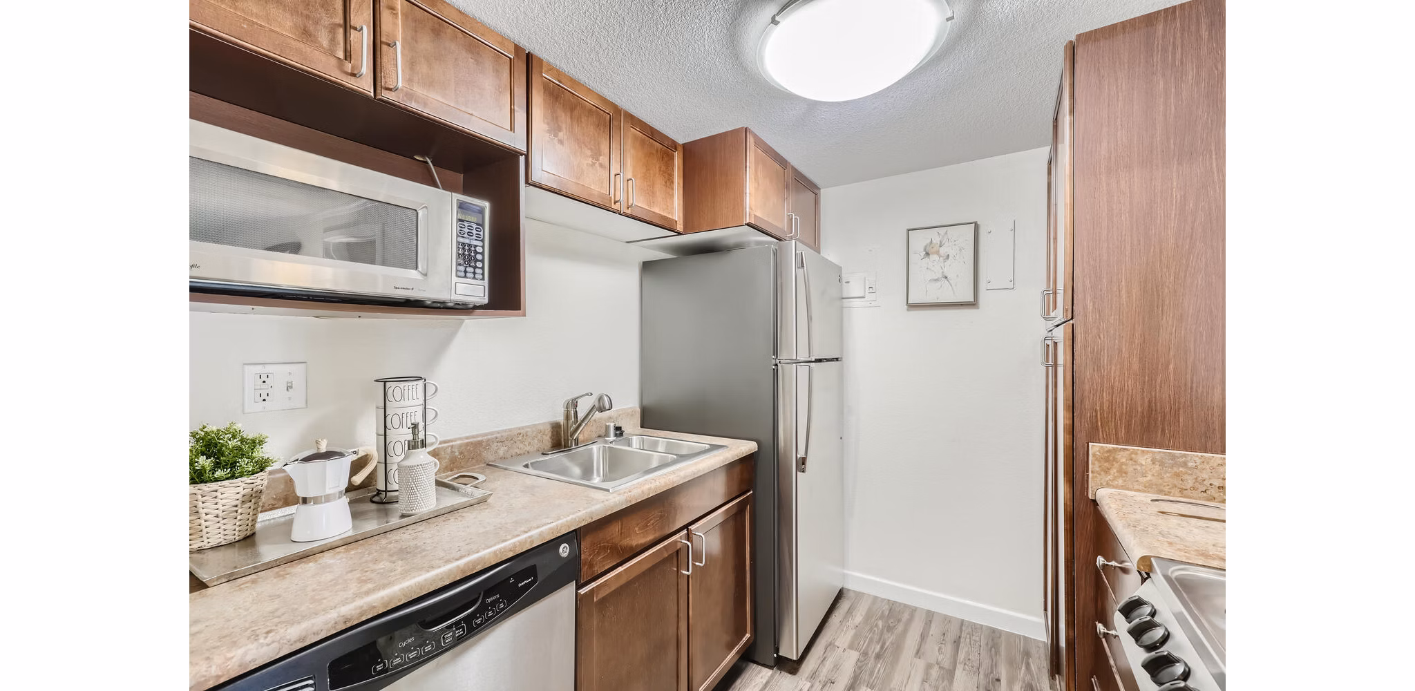 Modern kitchen featuring stainless steel appliances and granite countertops at Avantus Apartments