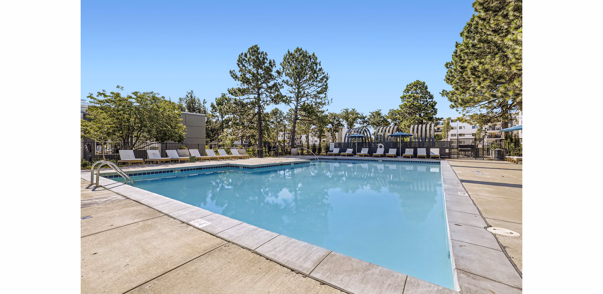 Luxurious poolside retreat at Avantus Apartments featuring lounge chairs and city views Ideal for relaxation at Greystar luxury apartments