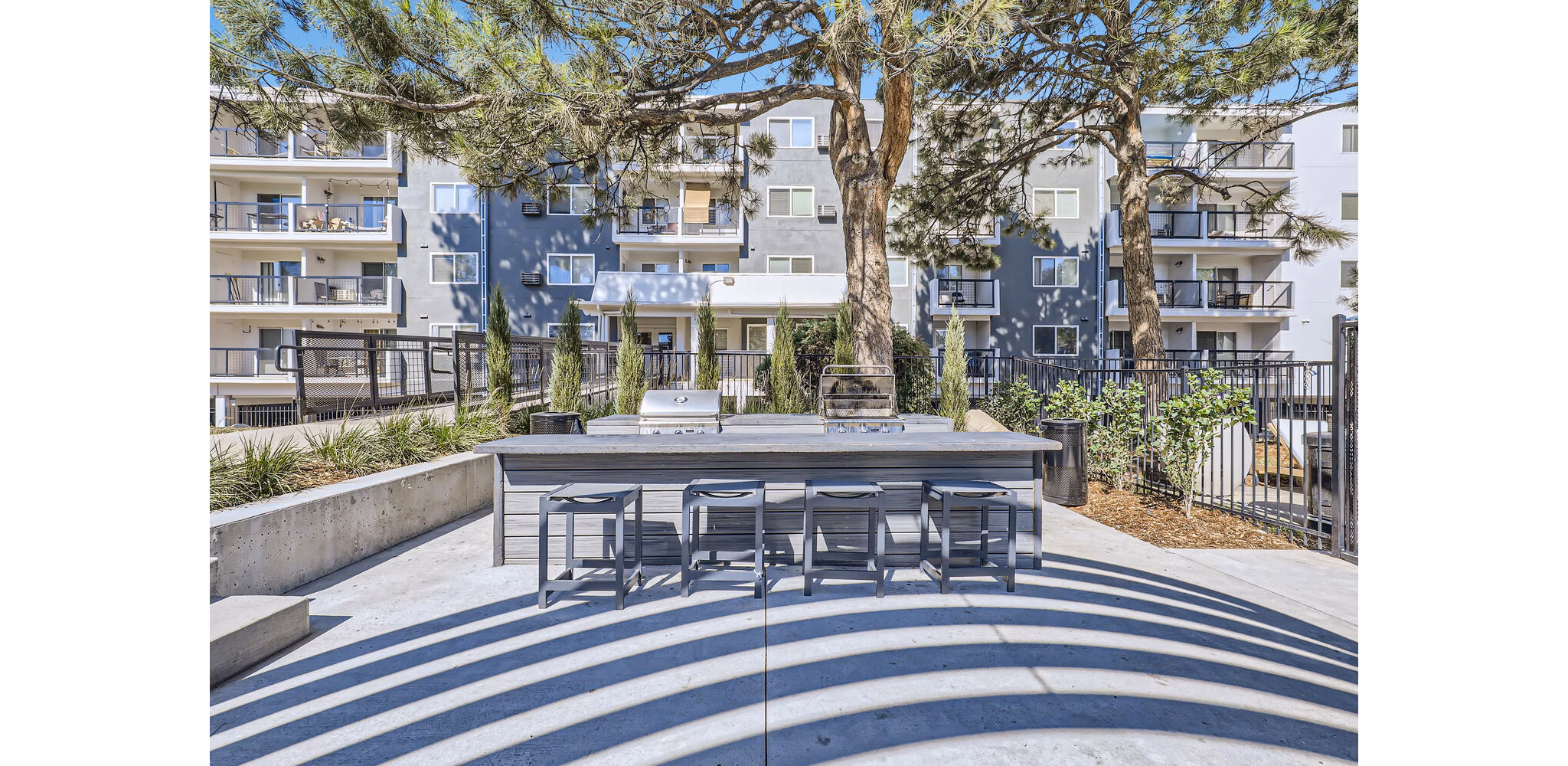 Grill area featuring modern outdoor seating at Avantus Apartments, Greystar luxury apartments in urban setting
