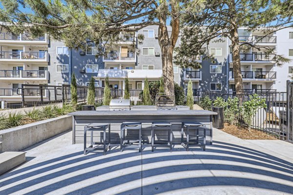 Grill area featuring modern outdoor seating at Avantus Apartments, Greystar luxury apartments in urban setting