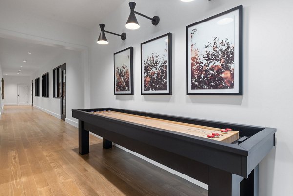 Game room with pool table and arcade games at Gladwen Wendell Falls Apartments
