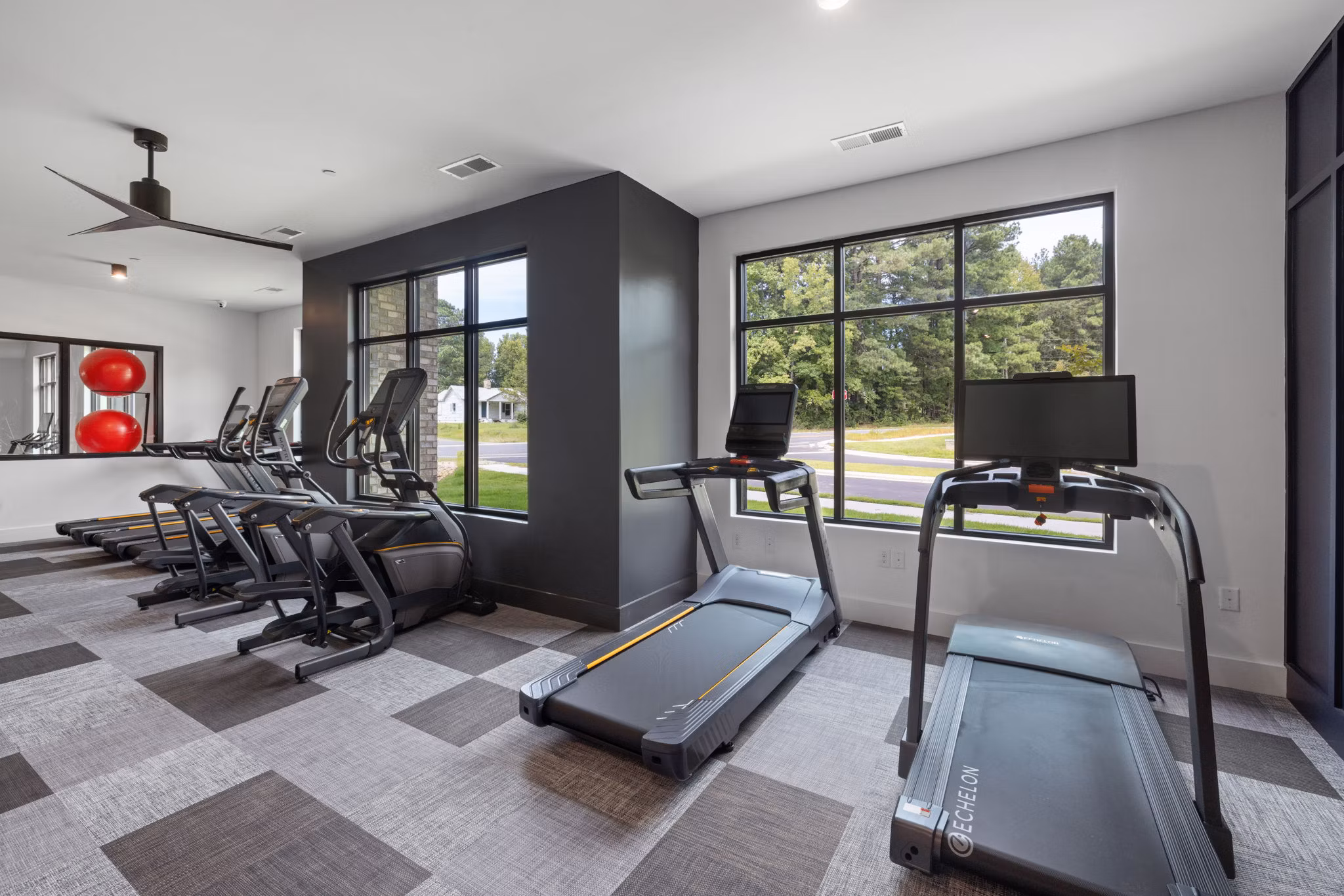 Modern fitness center with state-of-the-art equipment at Gladwen Wendell Falls Apartments, promoting active lifestyles for residents
