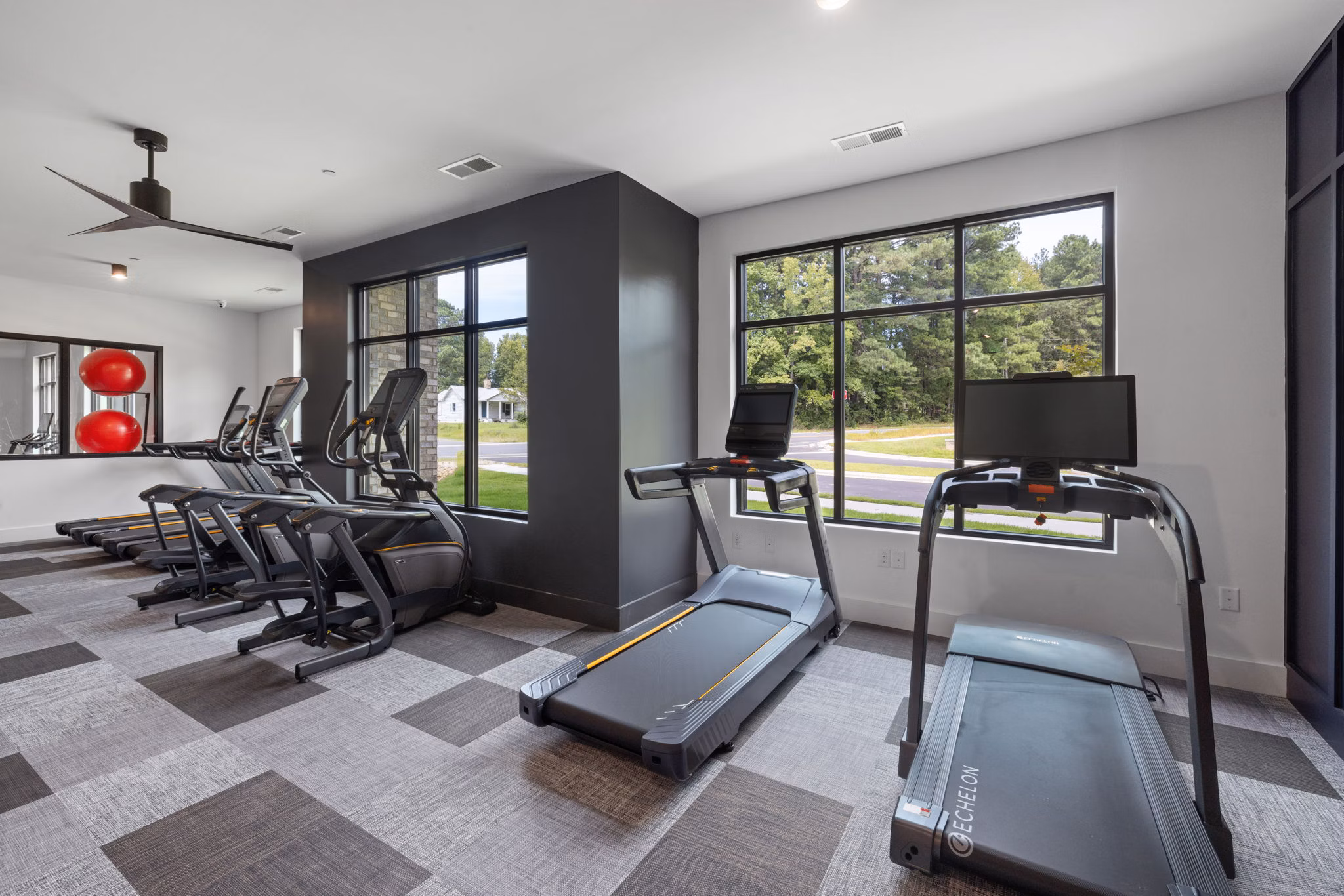 Modern fitness center with state-of-the-art equipment at Gladwen Wendell Falls Apartments, promoting active lifestyles for residents