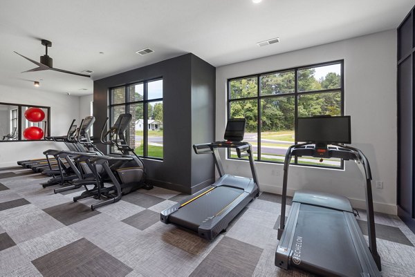 Modern fitness center with state-of-the-art equipment at Gladwen Wendell Falls Apartments, promoting active lifestyles for residents