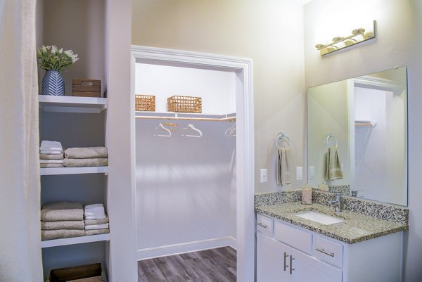 Cozy bedroom with modern furnishings in Windsor at Manhattan Apartments