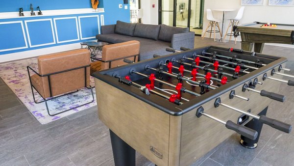 Modern game room with billiards and foosball at Windsor at Manhattan Apartments