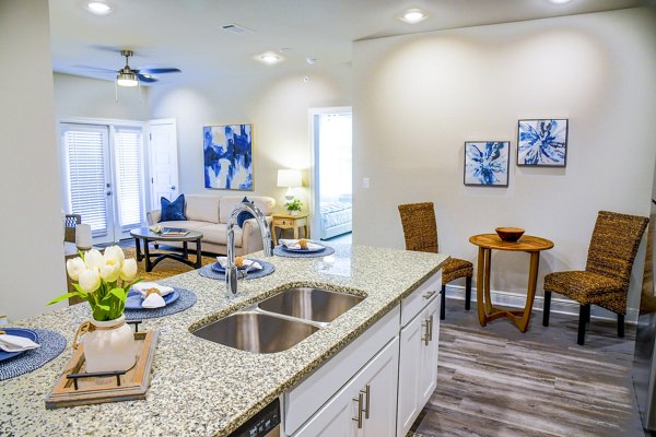 Kitchen and dining area featuring modern appliances and sleek finishes at Windsor at Manhattan Apartments