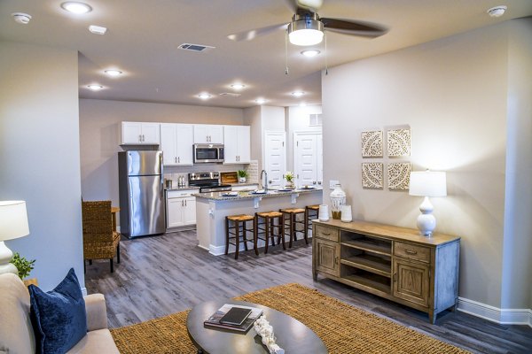 Spacious living room with elegant decor and open design in Windsor at Manhattan Apartments, luxury residence