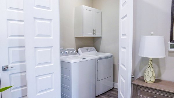 Laundry facility featuring modern appliances at Windsor at Manhattan Apartments