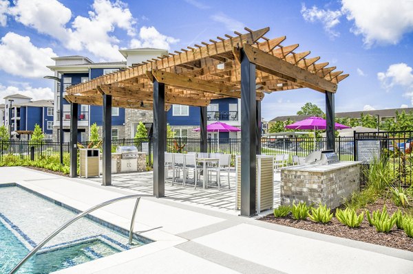 Grill area on a stylish patio at Windsor at Manhattan Apartments, perfect for outdoor dining and relaxation