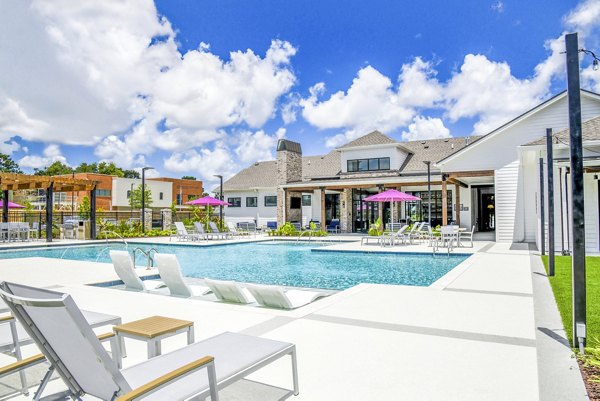 Inviting pool area with lounge chairs at Windsor at Manhattan Apartments