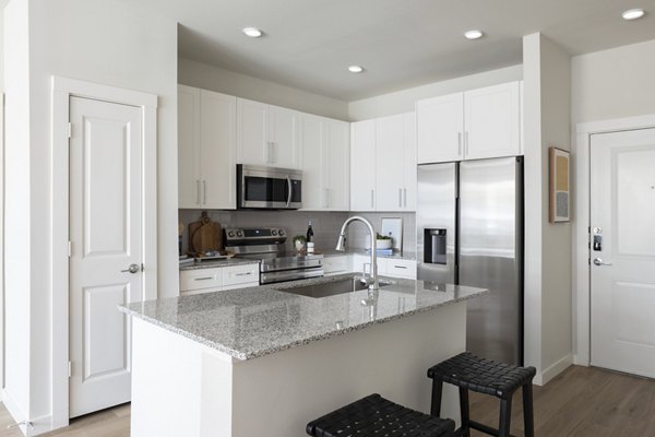 Kitchen with modern appliances and sleek cabinetry at Broadstone Baybrook Apartments