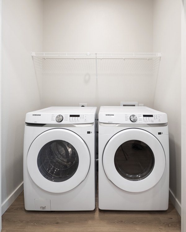 Laundry room with modern appliances at Broadstone Baybrook Apartments