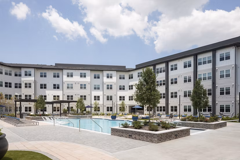 Relaxing pool with lounge chairs at Broadstone Baybrook Apartments offering luxury living in a serene setting
