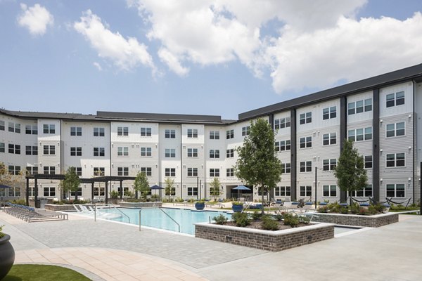 Relaxing pool with lounge chairs at Broadstone Baybrook Apartments offering luxury living in a serene setting