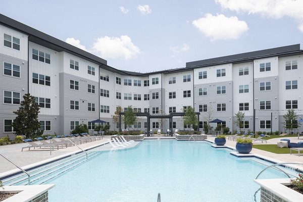 Resort-style pool surrounded by lounge chairs at Broadstone Baybrook Apartments