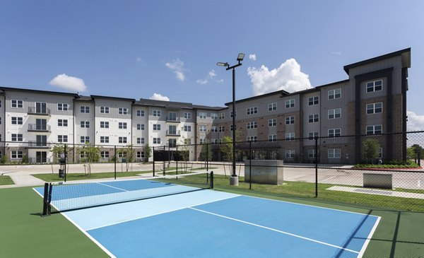 Outdoor sport court with basketball hoops at Broadstone Baybrook Apartments