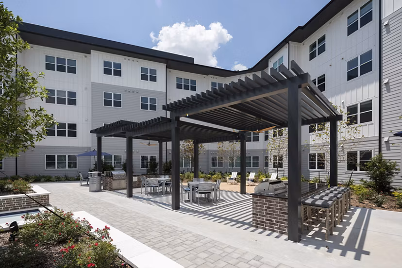 Outdoor grill area with modern seating at Broadstone Baybrook Apartments