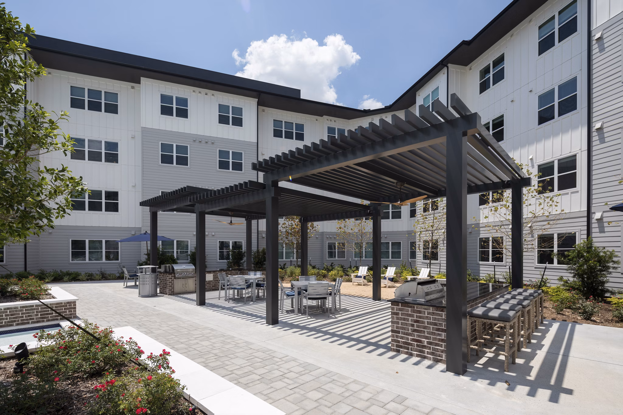 Outdoor grill area with modern seating at Broadstone Baybrook Apartments
