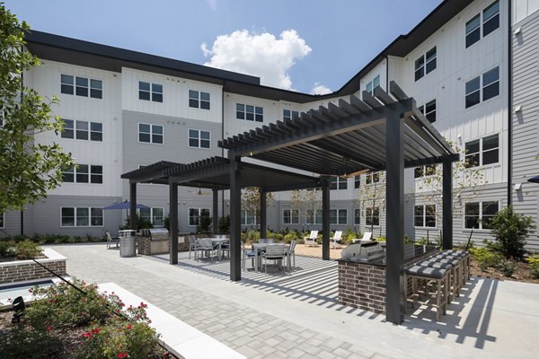 Outdoor grill area with modern seating at Broadstone Baybrook Apartments