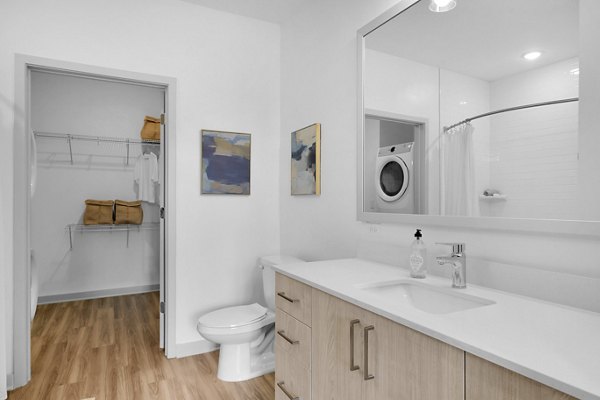 Bathroom featuring modern fixtures and sleek design in Alexan Research Park Apartments