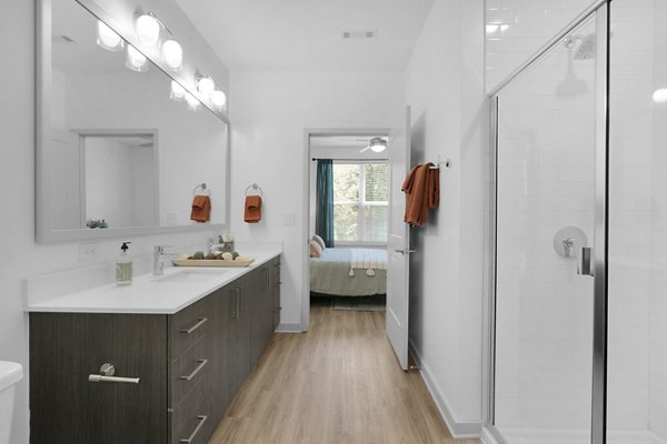 Luxurious bathroom with modern fixtures at Alexan Research Park Apartments