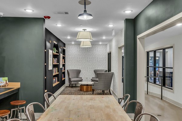 Clubhouse with modern seating and pool table at Alexan Research Park Apartments