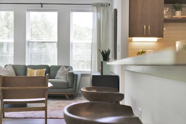 Modern dining area with stylish furnishings in Alexan Research Park Apartments