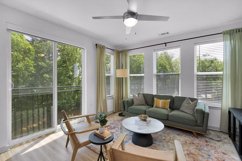 Alexan Research Park Apartments: Living room with modern design and ample natural light