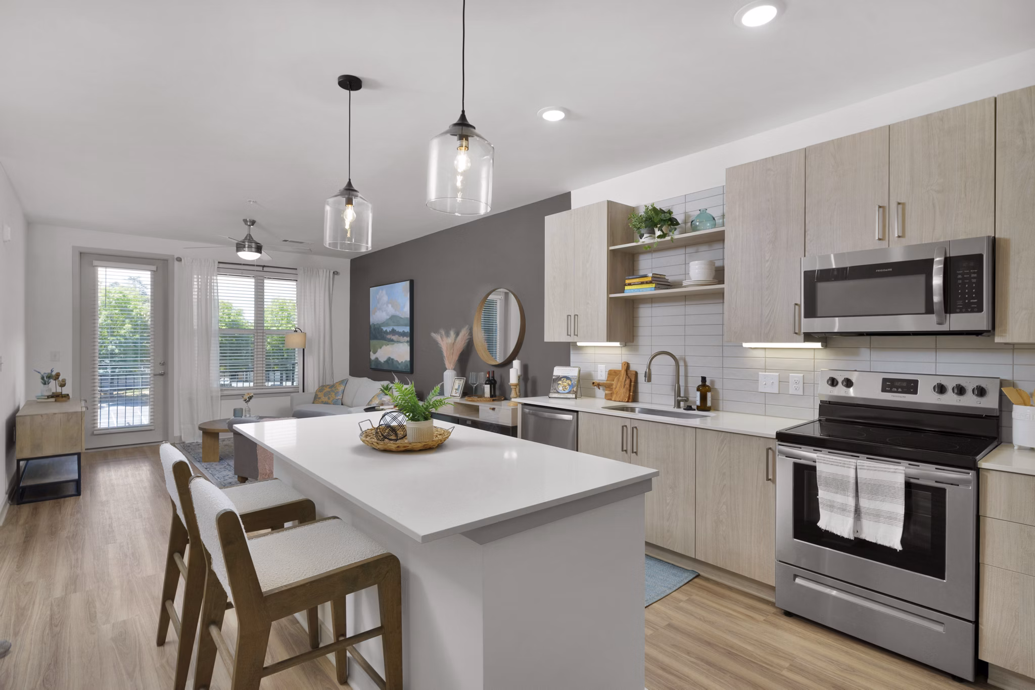 Modern kitchen with stainless steel appliances at Alexan Research Park Apartments