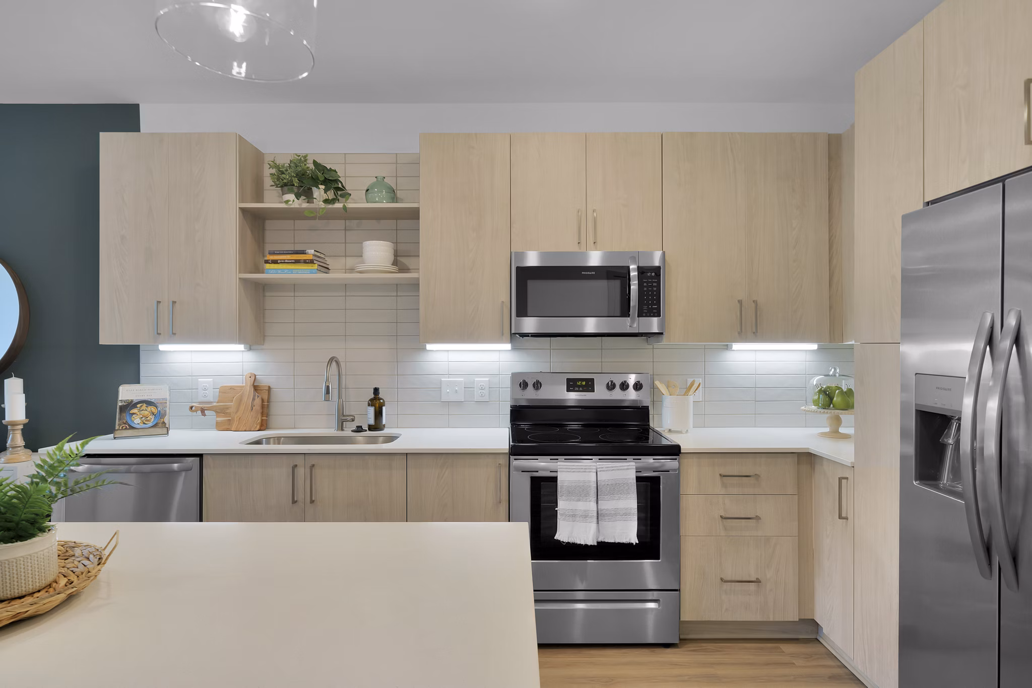 Modern kitchen with stainless steel appliances in Alexan Research Park Apartments