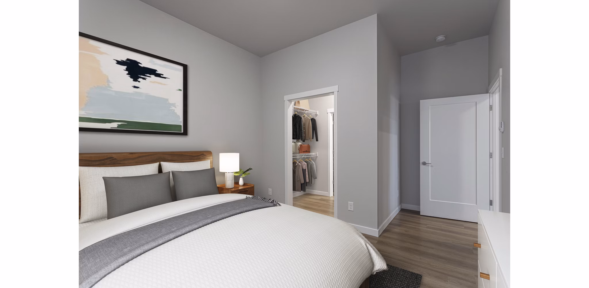 Cozy bedroom with natural light and minimalist decor at The Farmstead Apartments
