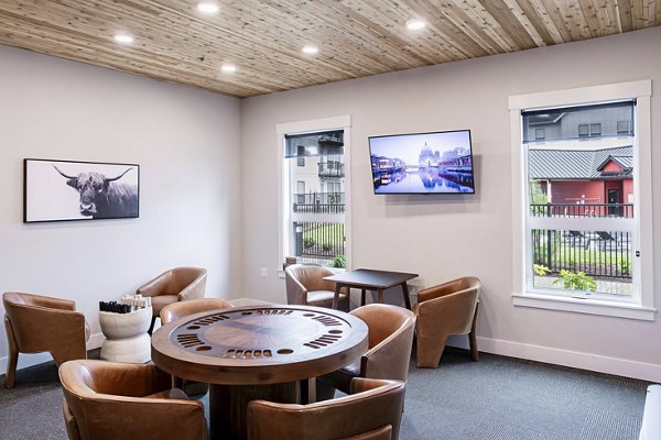 Clubhouse featuring modern design and seating areas at The Farmstead Apartments