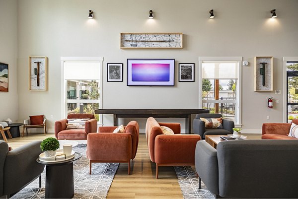 Clubhouse with modern design and cozy seating at The Farmstead Apartments offering luxury living by Greystar