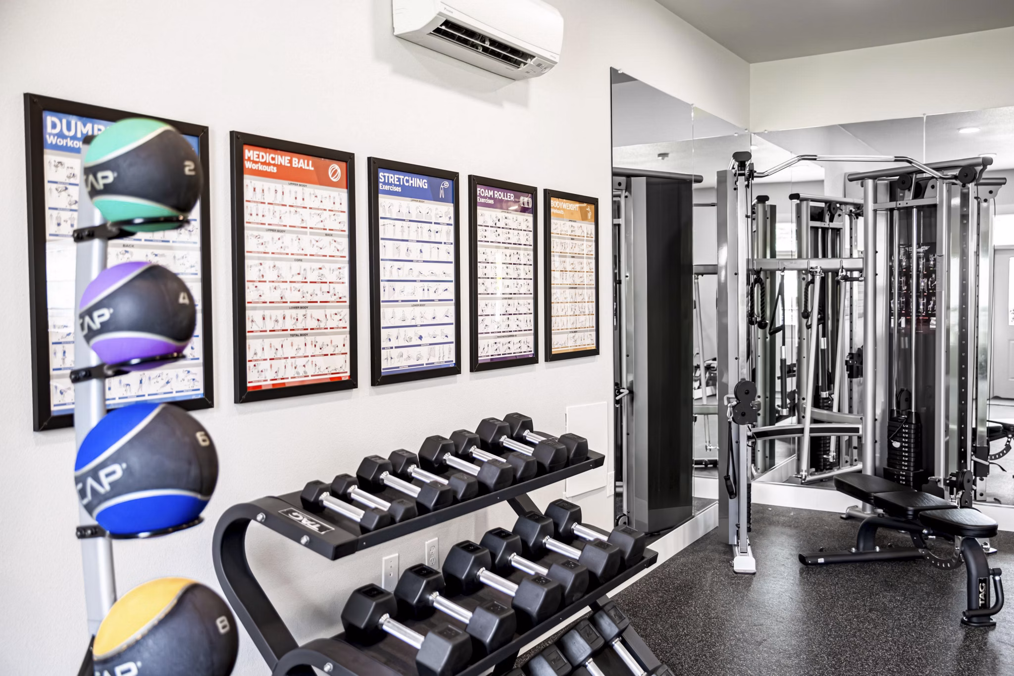 State-of-the-art fitness center with modern equipment at The Farmstead Apartments