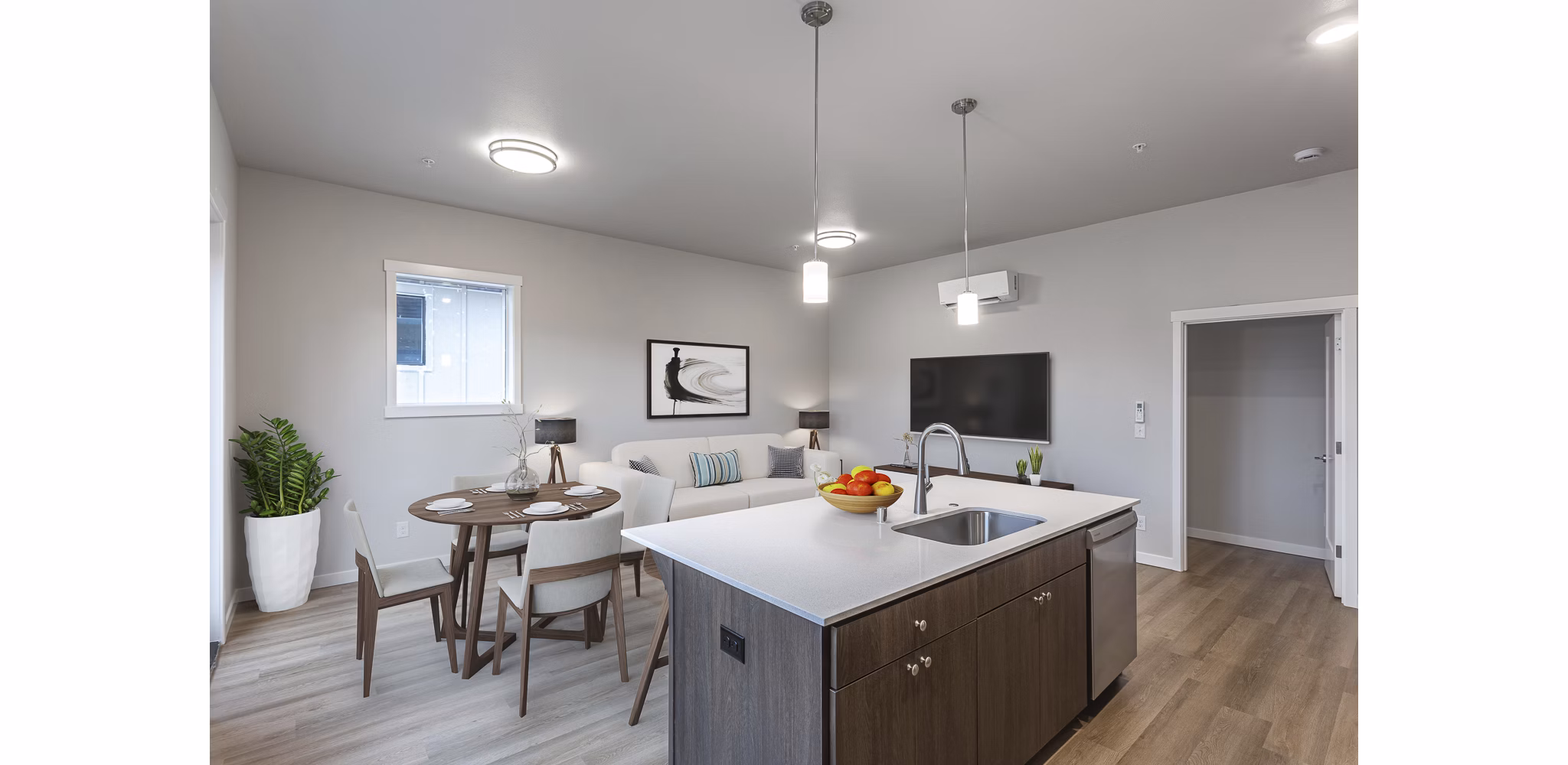 Modern kitchen with granite countertops and stainless steel appliances in The Farmstead Apartments