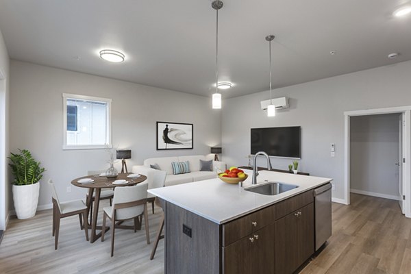 Modern kitchen with granite countertops and stainless steel appliances in The Farmstead Apartments