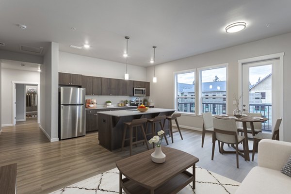 Elegant kitchen with modern appliances and granite countertops in The Farmstead Apartments