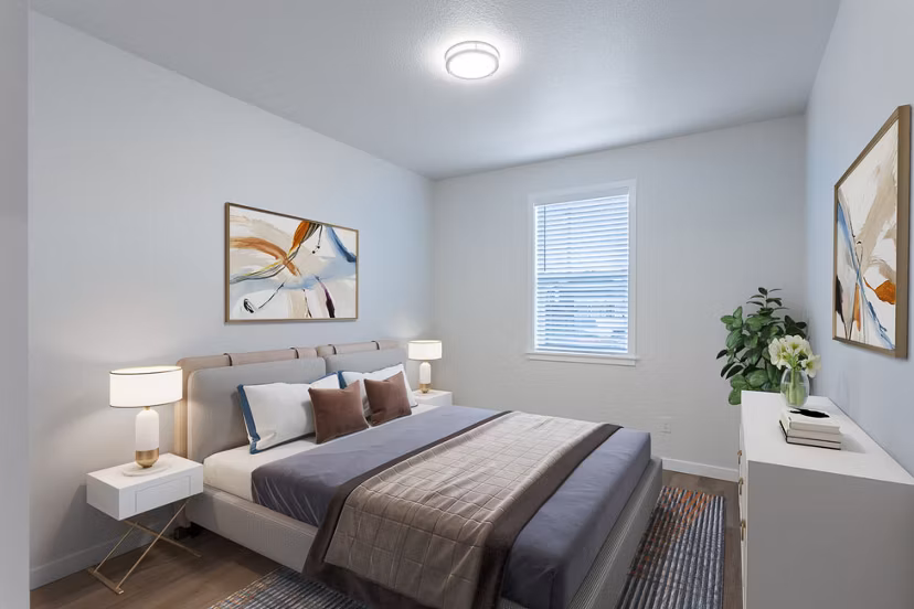 Bedroom featuring modern decor and large windows at Villas at 28th Apartments