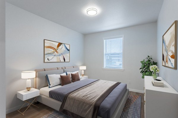 Bedroom featuring modern decor and large windows at Villas at 28th Apartments