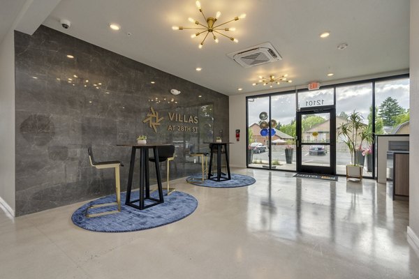 Stylish clubhouse featuring a modern lounge area at Villas at 28th Apartments