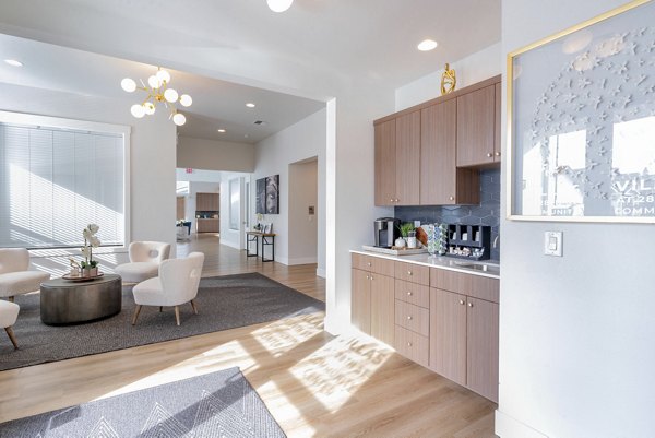 Clubhouse featuring modern decor and ample seating at Villas at 28th Apartments