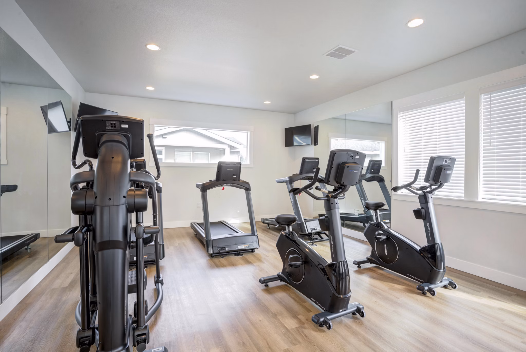 Yoga and spin studio with modern equipment at Villas at 28th Apartments, promoting fitness and wellness
