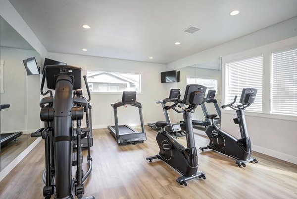 Yoga and spin studio with modern equipment at Villas at 28th Apartments, promoting fitness and wellness