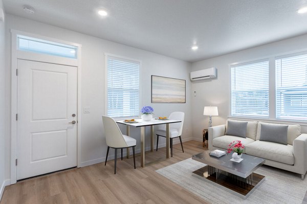 Modern living room with sleek furnishings at Villas at 28th Apartments